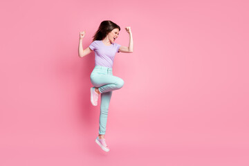Full length profile side photo of crazy ecstatic girl jump raise fists scream celebrate lucky win wear teal purple pants sneakers isolated over pastel color background