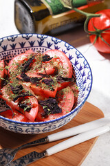 Salad with tomatoes and Basil. Fresh vegetables in a blue plate. Vegetable and vegetarian salad