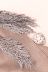 Fall Winter cozy background with autumn brunch decor and scarf. Trendy pastel beige brown color shades.  Minimalist aesthetic