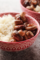 Rice with mushrooms. Traditional Chinese food. Chinese rice with chopsticks. Chinese cuisine in a pink bowl