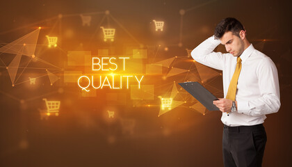 Businessman with shopping cart icons and BEST QUALITY inscription, online shopping concept