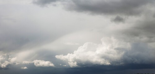 Bright and dark clouds looks like enigmatic figures in sky
