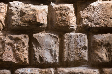 Ancient brick stone wall. Masonry wall of stones texture background. High quality photo.