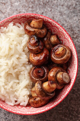 Rice with mushrooms. Traditional Chinese food. Chinese rice with chopsticks. Chinese cuisine in a pink bowl