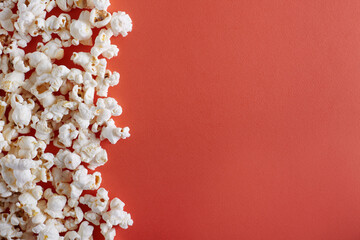 Popcorn on yellow or orange background with copy space top view.