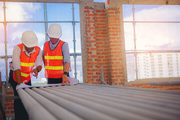 Structural engineer and foreman worker with touch pad discuss, plan working for building construction site. © Panumas