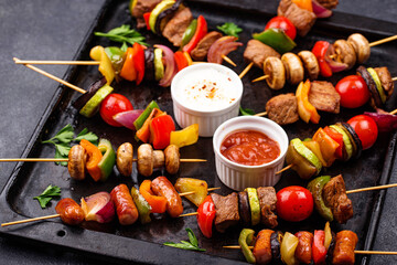 Grilled kebabs with meat, mushrooms and vegetables