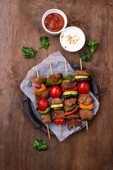 Grilled kebabs with meat, mushrooms and vegetables
