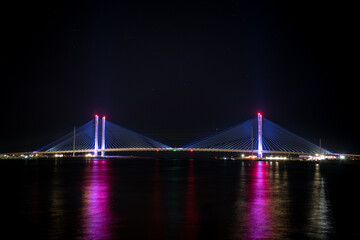 Fototapeta na wymiar The Indian River Inlet Bridge on the last day of Summer 2020. If you look closely there is a small shooting star between the bridge spans. A cable-stayed bridge located in Sussex County, Delaware.