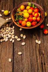 Harvest ripe cherry plum with seeds on wooden background
