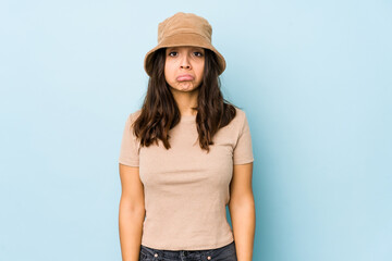 Young mixed race hispanic woman isolated blows cheeks, has tired expression. Facial expression concept.