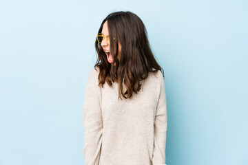 Fototapeta premium Young mixed race hispanic woman isolated shouting very angry, rage concept, frustrated.