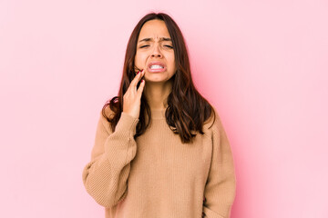 Young mixed race hispanic woman isolated having a strong teeth pain, molar ache.