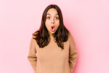 Young mixed race hispanic woman isolated being shocked because of something she has seen.