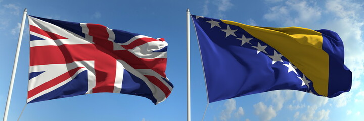 Waving flags of Great Britain and Bosnia and Herzegovina on flagpoles, 3d rendering