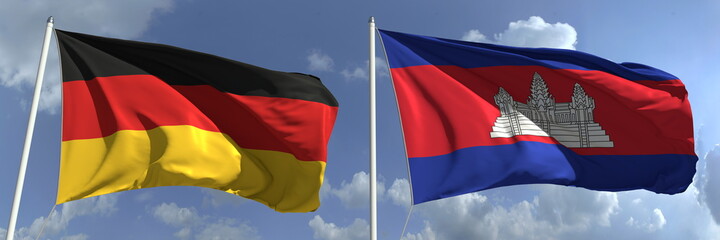 Flags of Germany and Cambodia on flagpoles. 3d rendering