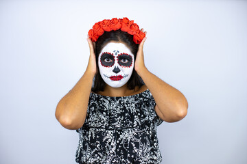 Woman wearing day of the dead costume over isolated white background thinking looking tired and bored with hands on head