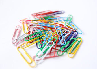 Colored paper clips close-up on a white background