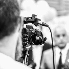 Press Conference Outdoors. Cameraman at a Media Event