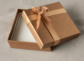 open golden square gift box on gray background