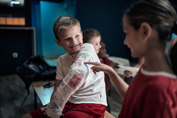 Injured a little soccer player showing his broken arm