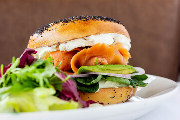 Smoked salmon and cream cheese bagel with salad. Restaurand brunch dish