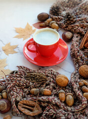 autumn composition with coffee Cup, scarf, nuts, autumn leaves on marble background. atmosphere cozy fall season, thanksgiving day concept.