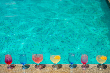 sweet chers drinking cold lemonade in swimmingpool