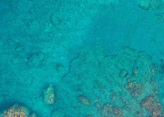 Image of the turquoise sea. Sea and corals. Top view of beautiful Caribbean Sea. Aerial drone shot of turquoise water. Aquamarine background.