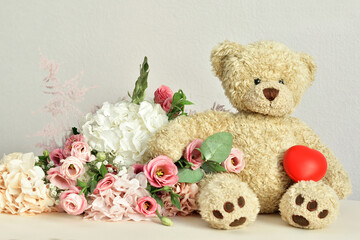 bouquet of delicate pink flowers and present box.Teddy bear. Valentines Day 14 February.Greeting card for Birthday, Woman or Mothers Day. I love you concept.Good morning.Selective focus.Copy space.