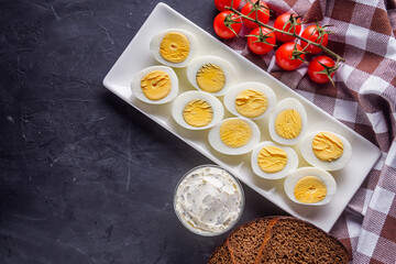 boiled chicken eggs on a dark stone background