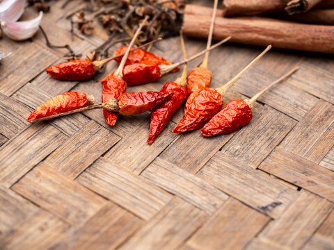 Top view of colourful spices chilis in wooden tray. Asian popular cooking ingredients, dry hot healthy cook herbs. view form above and copy space background.
