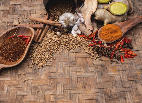 Top view of colourful spices in wooden tray. Asian popular cooking ingredients, dry hot healthy cook herbs. view form above and copy space background.