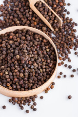 fragrant black pepper on white acrylic background