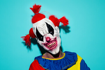scary evil clown on a blue background