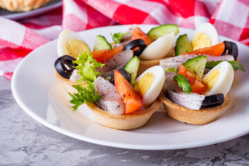delicious snack tartlets on dark stone background