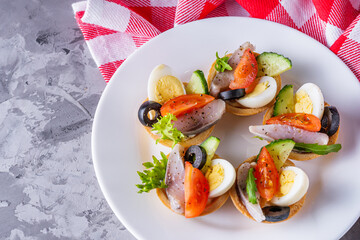 delicious snack tartlets on dark stone background