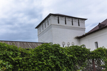 A square white tower with loopholes.  Hipped roof  over the towers. Panfutyevsky Monastery in Borovsk, Russia.