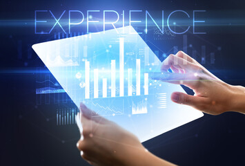 Hand holding futuristic tablet with EXPERIENCE inscription above, modern business concept