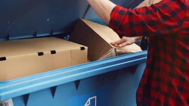 Caucasian Male Leaving Cardboard Paper in Blue Garbage Bin For Further Recycling 4k