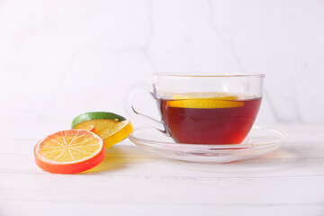 Close up of lemon tea on wooden background.
