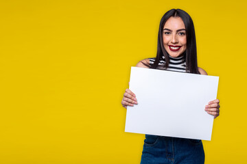 Fototapeta na wymiar Woman holding white sign, isolated on yellow background with space for text