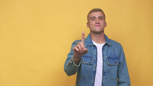 Young caucasian man showing number one with finger