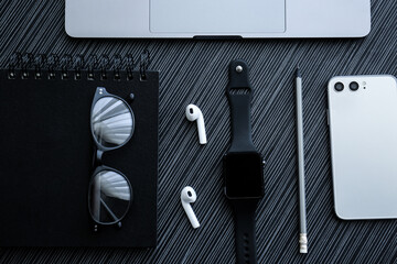 Flat lay composition with stylish smart watch on black table