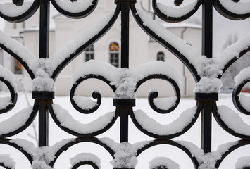 patten iron fence covered by snow