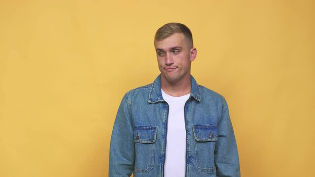 Young caucasian man confused, feels doubtful and unsure
