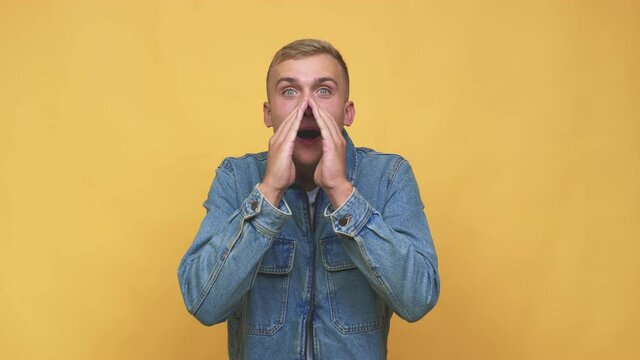Young caucasian man shouting excited to front