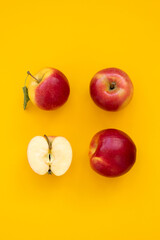 Fresh red Gala apples on yellow background. Top view. Flat lay