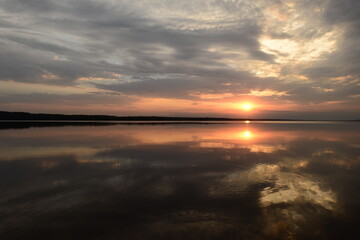 Fototapeta premium Majestic sunset reflected in the calm water lake