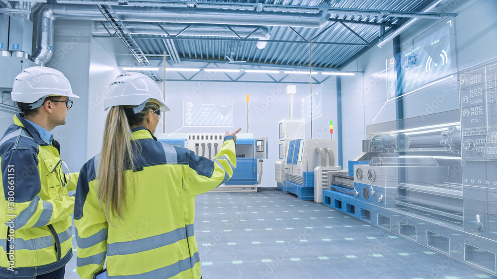 Poster Two Engineers Standing and Talking in Factory Workshop with Augmented Reality 3D Models CNC Machinery Production Line. Industry 4.0 Graphics Visualization in Factory. VFX Special Graphics Effects